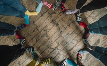 Taken when an office came together to support World Down Syndrome Day 2019. Part of the #LotsOfSocks campagne, this image looks down at a circle of mismatched socks! Patterns of every colour stand side by side showing friendship and unity.