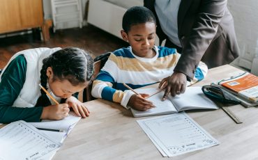 Teacher helping student improve handwriting