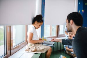 Registered behavior technician helping a child in the classroom