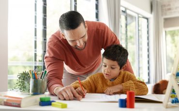 male teacher helping student with writing